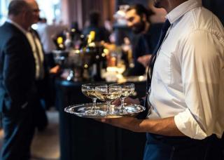 waiter carrying champagne at event